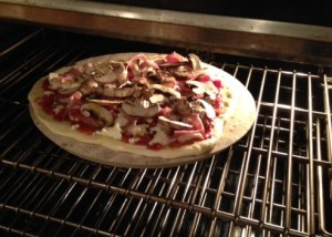 Pizza on pizza stone in oven